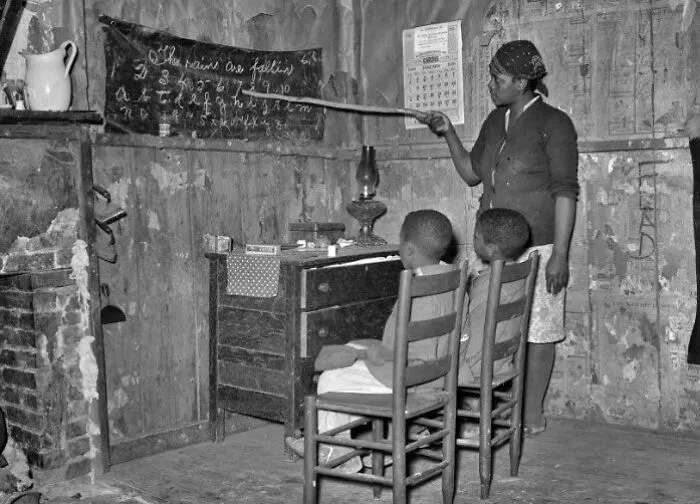 A Sharecropper Mother From Transylvania, Louisiana, Educates Her Children At Home, Focusing On Letters And Numbers (1937)