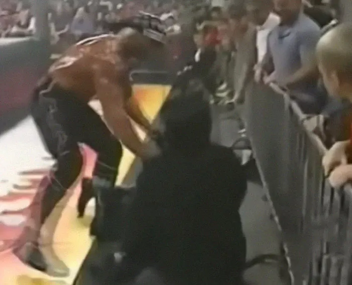 Wrestling fight breaking out near the ring barricade, capturing one of the most shocking moments on live television.