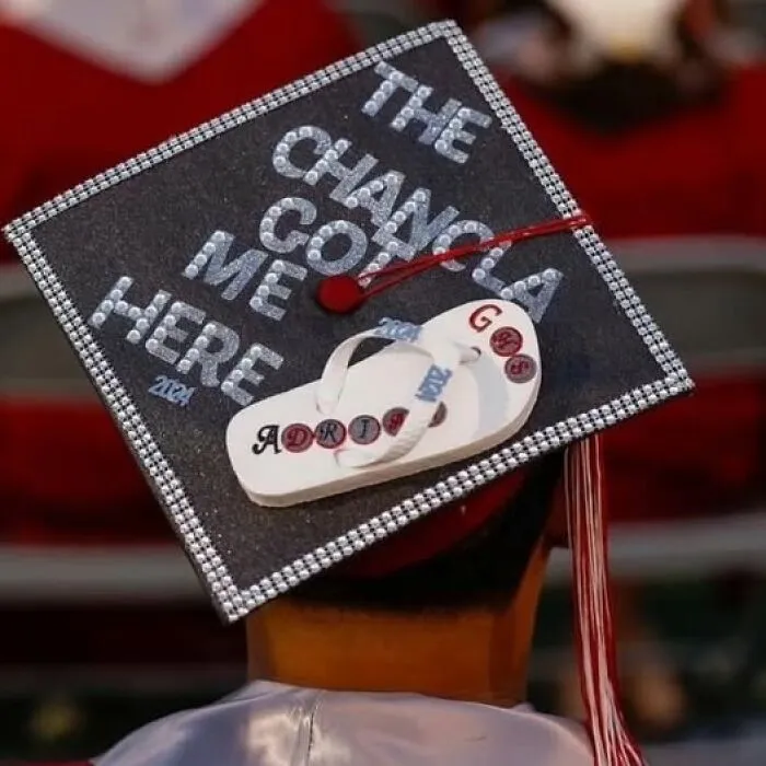 Graduation cap decorated with a flip-flop and text, reflecting humorous Hispanic culture in funny memes.