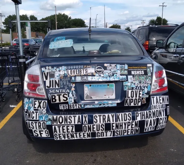 Car covered in K-pop themed stickers and decals, an example of outrageous car mods that took things way too far.