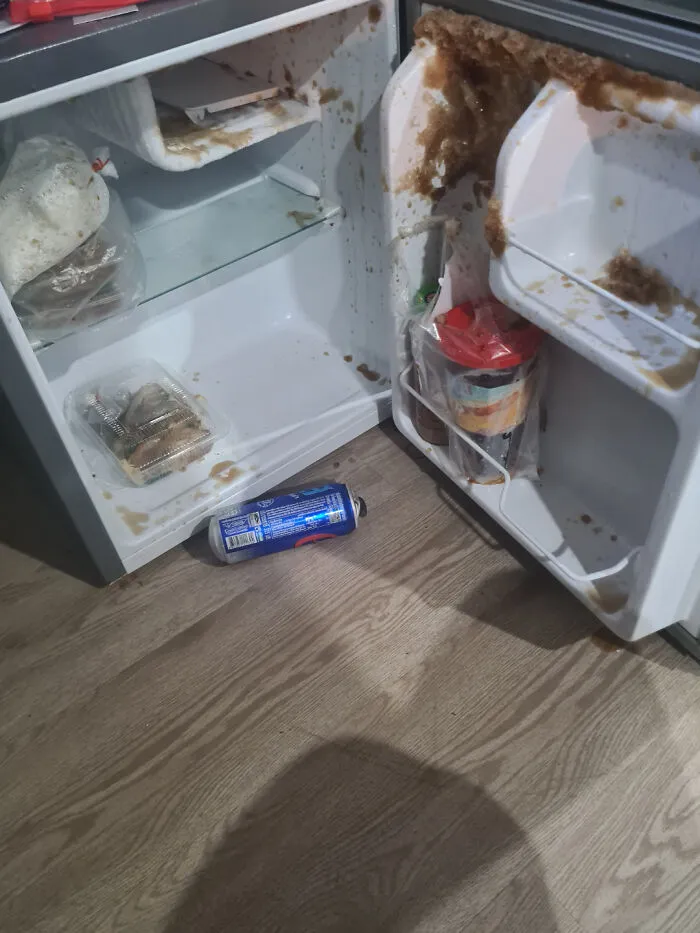 Open fridge with spilled soda causing a sticky mess, illustrating a funny unfortunate situation from forgetting something.