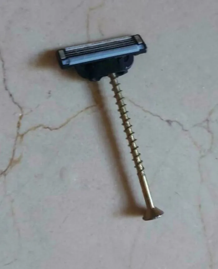 Razor head attached to a long screw, an example of redneck engineering and creative MacGyvering.