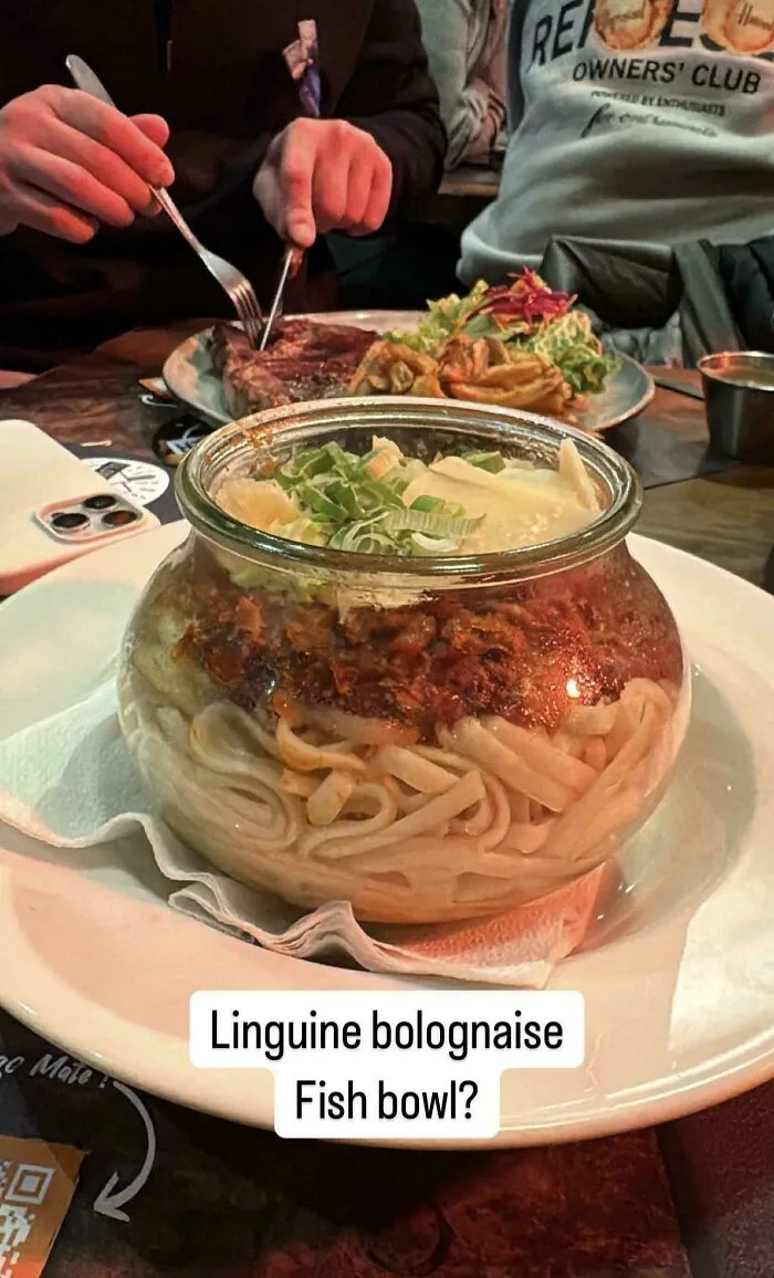 Linguine bolognaise served in an unusual glass fish bowl, highlighting unholy meal presentation ideas.