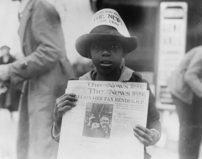African American Boy Selling The Washington Daily News - Sign On His Hat Reads, "Have You Read The News? One Cent" - Headline Reads "Millionaire Tax Rends G.o.p.", 1921