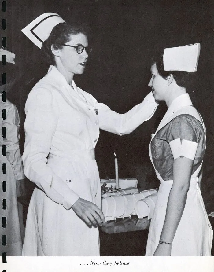 Vintage photo of nurses in traditional uniforms during a nursing ceremony symbolizing healing and hope in healthcare.