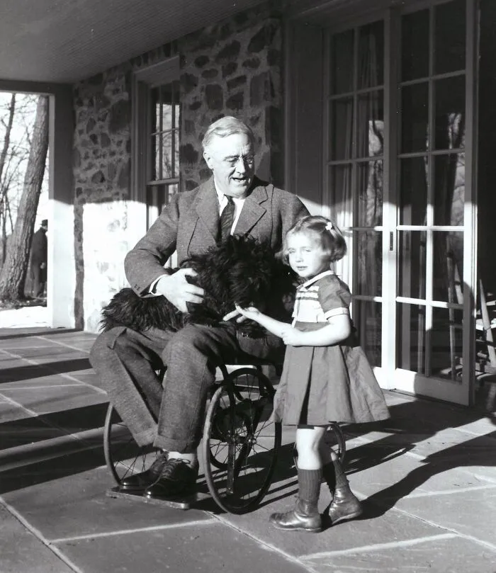 President Roosevelt In His Wheelchair On The Porch At Top Cottage In Hyde Park, NY, With Ruthie Bie And Fala, 1941