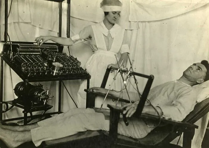 Vintage medical device in use with nurse and patient, showcasing unsettling medical technology from the past.