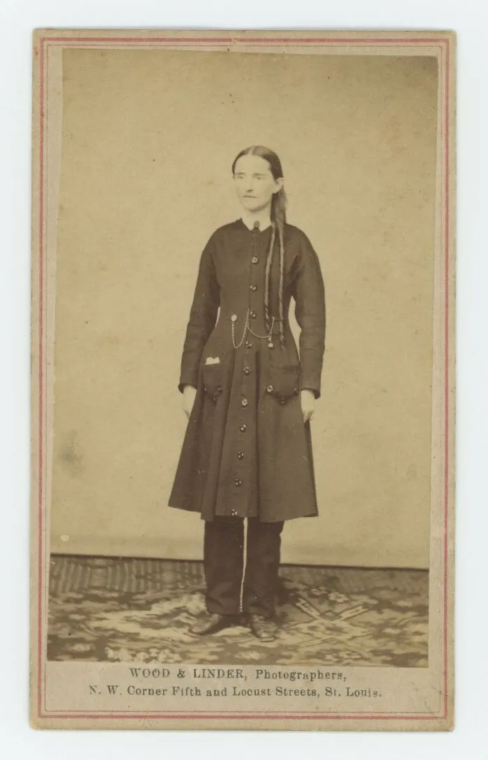 Vintage sepia photo of a woman wearing an old-fashioned dress, one of the most interesting and beautiful old things owned.