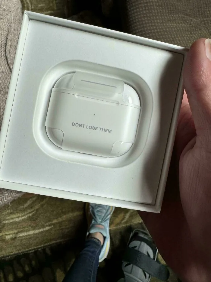 White wireless earbuds case in a box with text dont lose them, highlighting funny unfortunate situations of forgetting items.