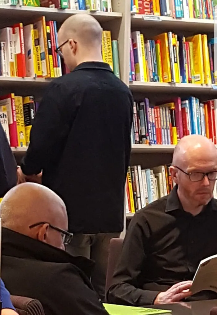 My Friend And I Went To A Bookshop And The Matrix Glitched (He's The Bald Dude In Black And Glasses)