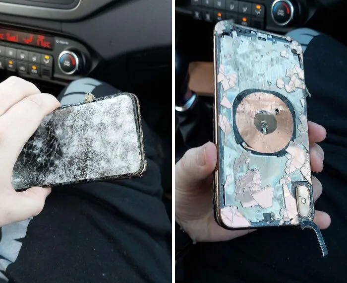 Cracked and damaged phone held in hand inside car, illustrating funny unfortunate situations of forgetting something important.