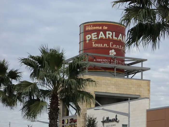 Welcome to Pearland Town Center sign with palm trees, representing top places to live in the USA for settling down.