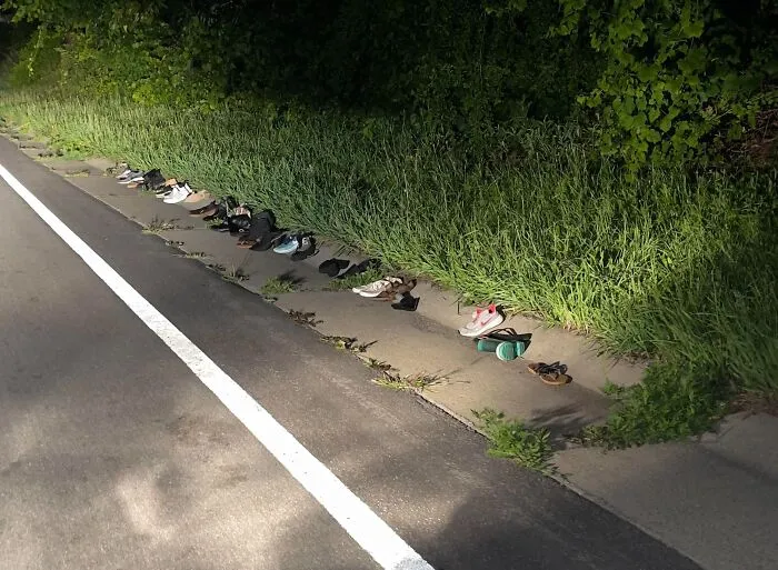 Driving At Night In Rochester NY And Stumbled Across A Line Of Children’s Shoes By The Woods