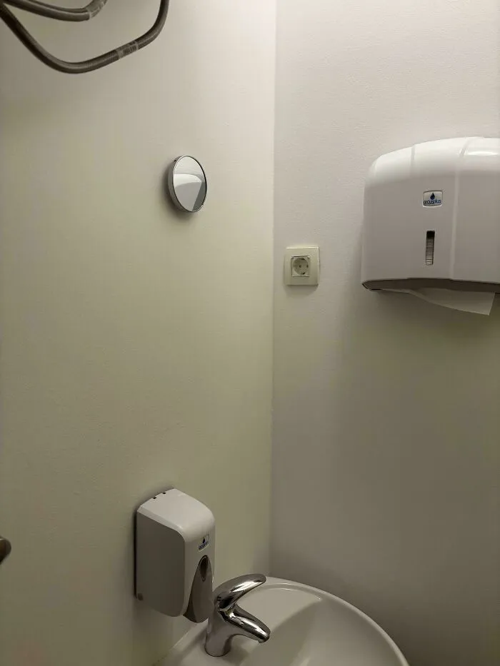 Small, poorly equipped school bathroom with minimal fixtures and basic hygiene supplies highlighting inequalities in schools.