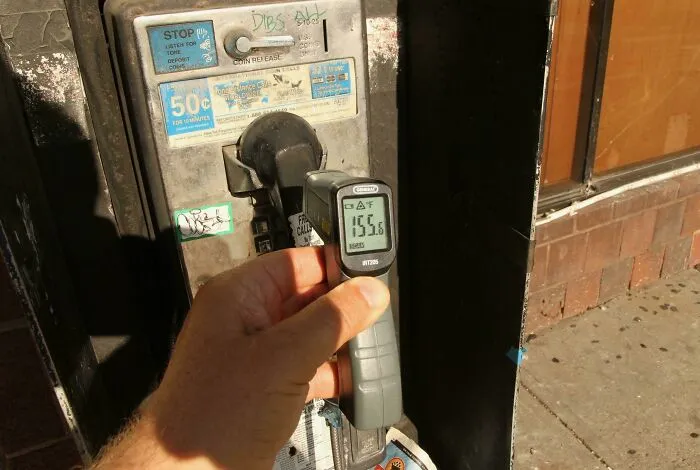 Fui a buscar por mi vecindario el objeto más caliente que pude encontrar durante esta ola de calor y el ganador fue la pieza de plástico de este teléfono público roto a 68 grados celsius.