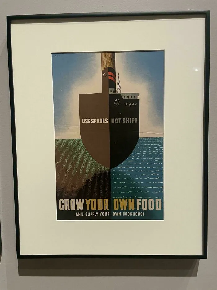 Framed vintage poster showing a shovel shaped like a ship promoting growing your own food and smart design.