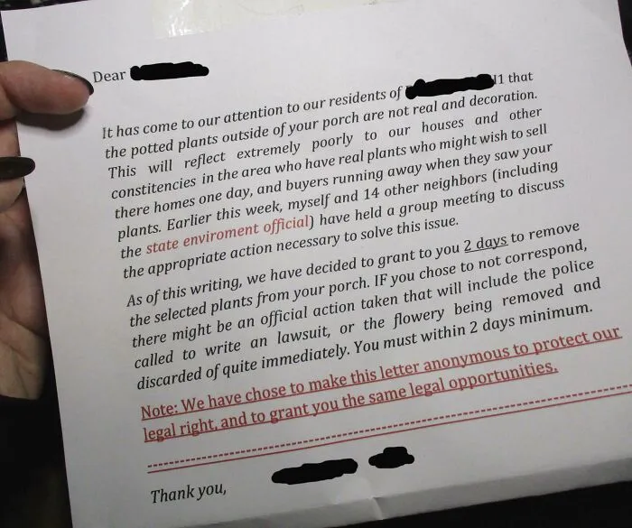Handwritten unhinged neighbor’s note demanding removal of fake porch plants in a tense residential dispute.