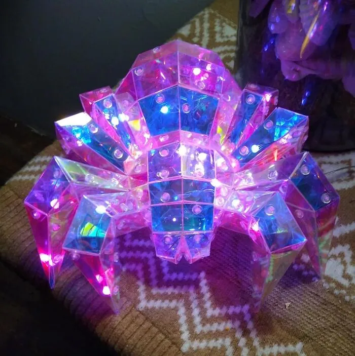 Elevate Your Space From "Room" To "Interdimensional Portal" With A <a Style="Display:inline;" Href="Https://Www.amazon.com/Glowing-Handmade-Ornament-Adjustable-Brightness/Dp/B0d945jgfh?ie=utf8&linkcode=ll1&tag=bpbobcat-20&linkid=6541f9aa7d829609dc051edee7080220&language=en_us&ref_=as_li_ss_tl" Target="_blank">  <span Style="Font: Inherit; Color: #d74b1f;"> Geometric Holographic Spider Lamp</Span>