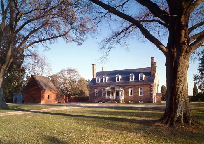 Historic home with classic colonial architecture surrounded by large trees and spacious lawn reflecting America’s architectural heritage.