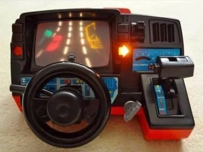 Vintage 90s driving video game toy with steering wheel, gear shift, and simple pixelated road graphics, evoking 90s nostalgia.