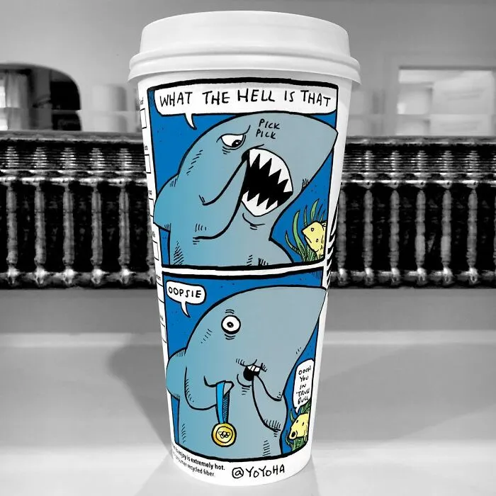 Coffee cup featuring a cartoon shark with humorous dialogue, showcasing relatable cartoons by a creative artist.