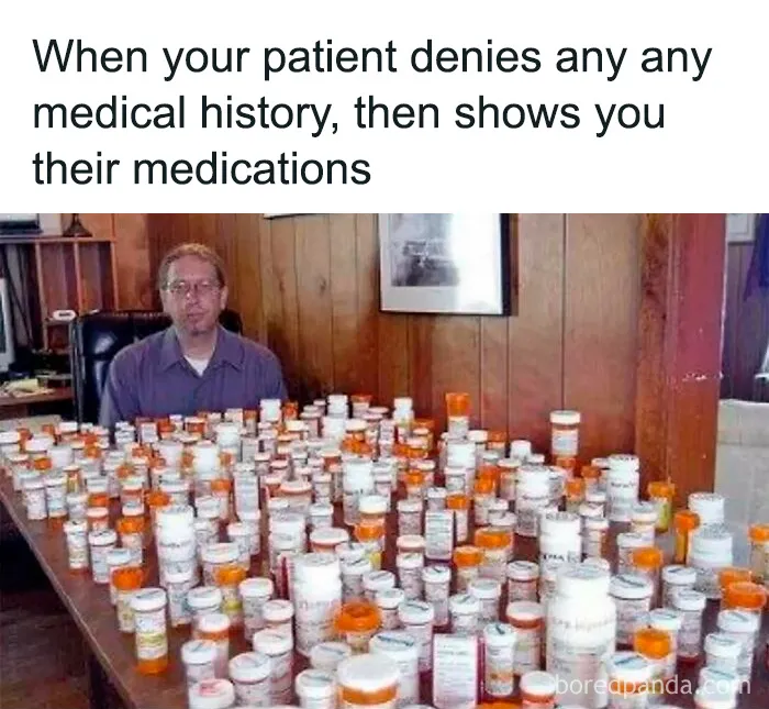 Man sitting behind table filled with numerous prescription bottles illustrating medical memes about expensive healthcare.