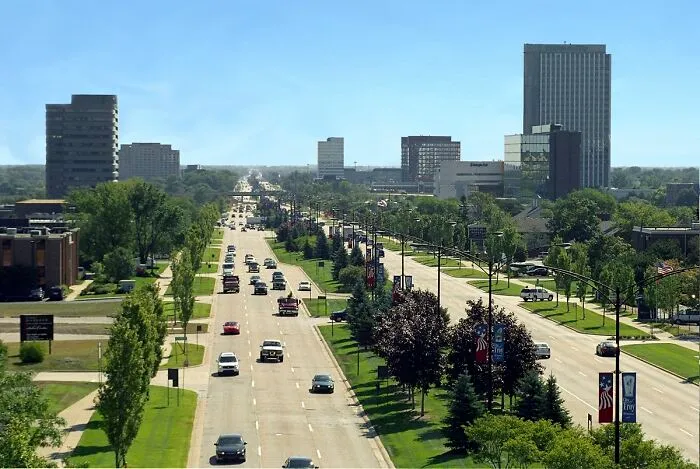 Wide view of a busy city street with buildings and greenery showcasing one of the best places to live in the USA.