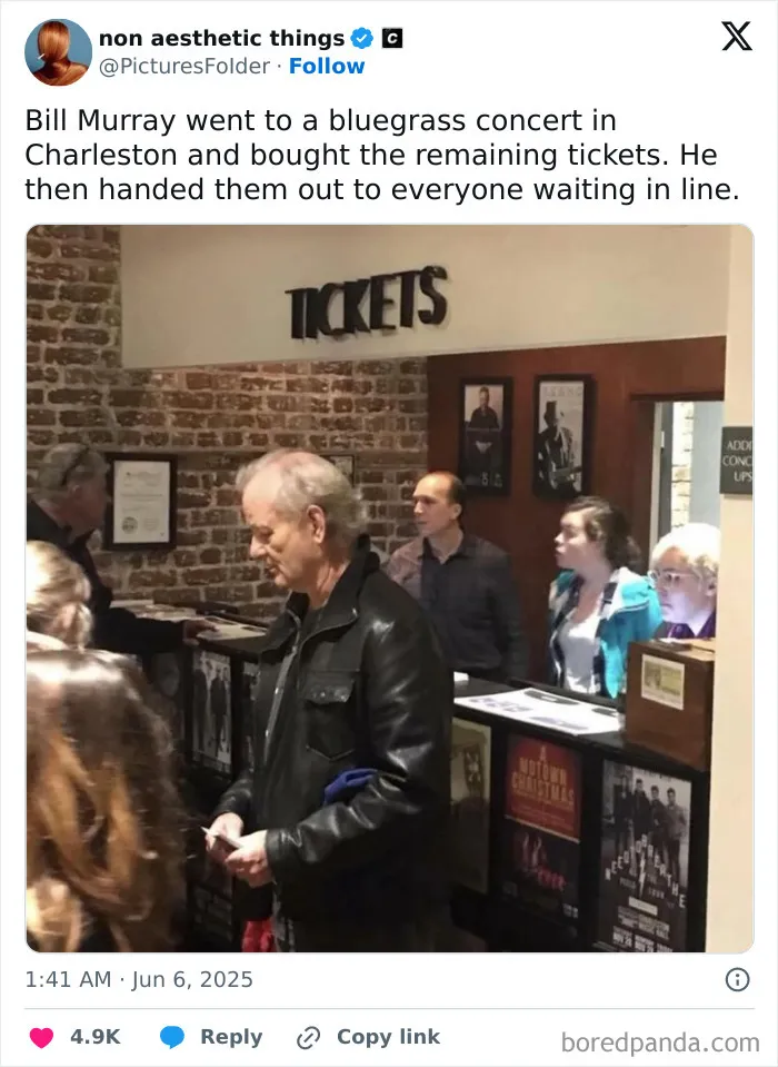 Bill Murray at a ticket counter handing out tickets to people in line, spreading positivity and kindness.
