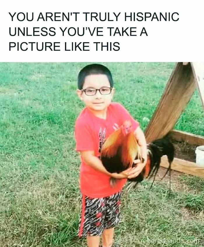 Young boy in glasses holding a rooster outdoors, a funny meme capturing what it’s like being Hispanic.