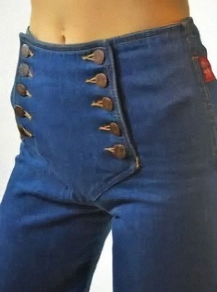 High-waisted vintage jeans with unique button closure detailing, showcasing a weird and wonderful retro fashion style.
