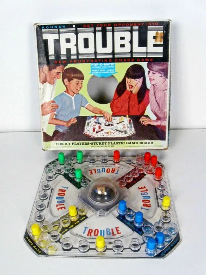 Vintage Trouble board game with colorful pegs and original box, showcasing classic vintage things in a nostalgic setting.