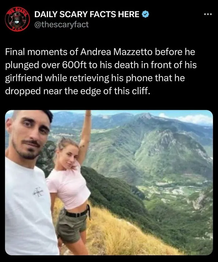 A couple taking a selfie on a cliff edge overlooking a mountainous landscape, illustrating scary fact about fatal fall.