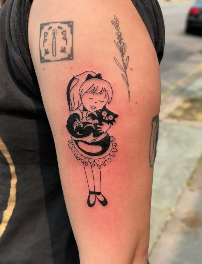 Black ink tattoo of a girl hugging a cat, surrounded by floral and abstract designs on an upper arm.