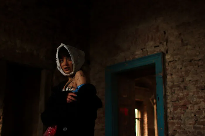 A Veiled Witness In The Theater Of Collapse, Dressed For The Aftermath