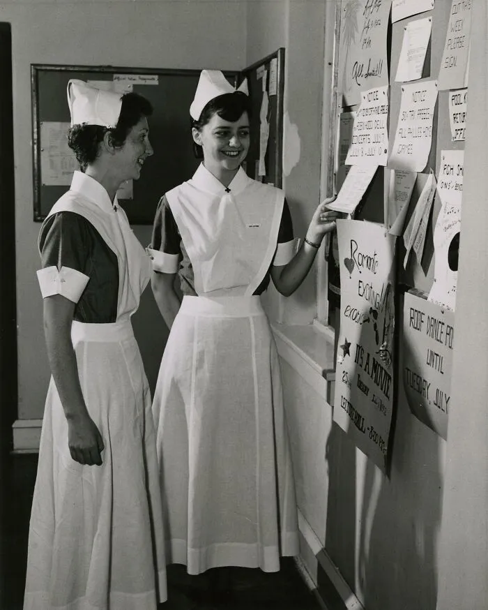 Jacqueline Dugan '54, Jane Hartman '54, Checking The Bulletin Board