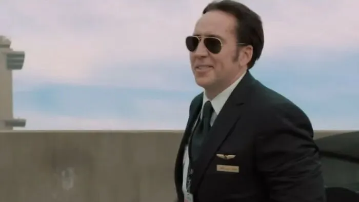Man in sunglasses and pilot uniform standing outdoors, representing themes of worst movies in cinematic history.