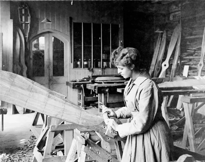 A Female Worker Shapes A Wooden Aeroplane Propeller At The Aircraft Factory Of Frederick Tibbenham Limited At Ipswich