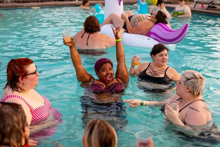 Group of travelers enjoying a lively pool party, sharing fun and surprising moments while visiting the U.S.