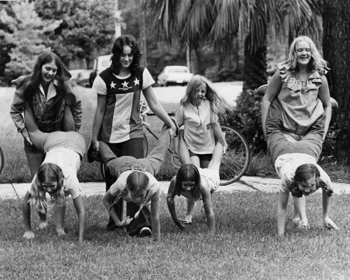Photographers Dughi's Sisters And Other Girls Hold A "Wheelbarrow" Race On The Front Lawn - Tallahassee, Florida, 1974