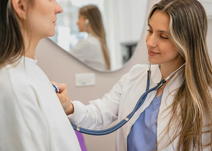 Doctor using a stethoscope to examine a patient, highlighting insights doctors wish more people knew.