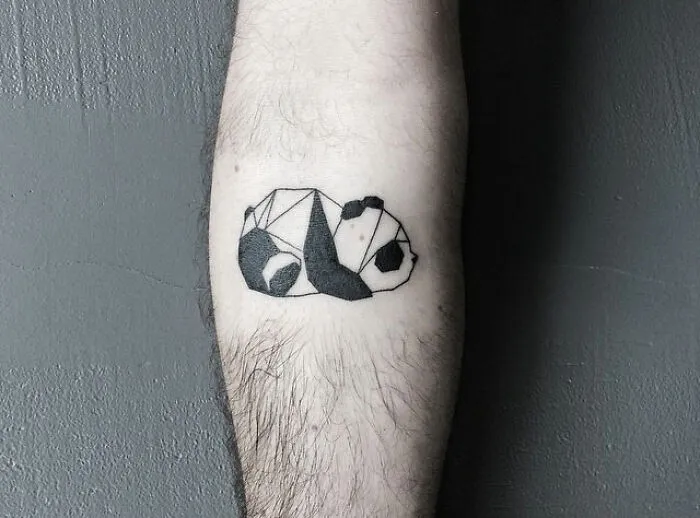 Geometric panda tattoo in black ink on a person's forearm showcasing one of the best tattoos appreciated by many.