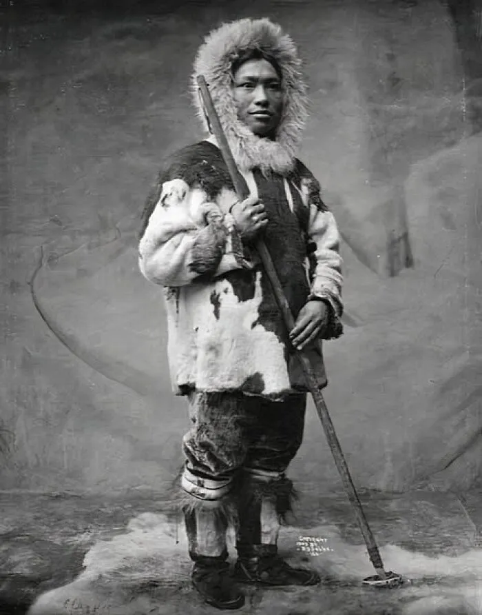 Inuit Man Dressed In A Fur Parka, Pants And Boots Holding A Stick, Alaska, 1903