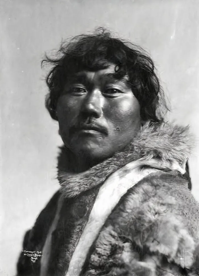 Portrait of an Inuit man wearing traditional fur clothing, showcasing the historic spirit of the Inuit people.