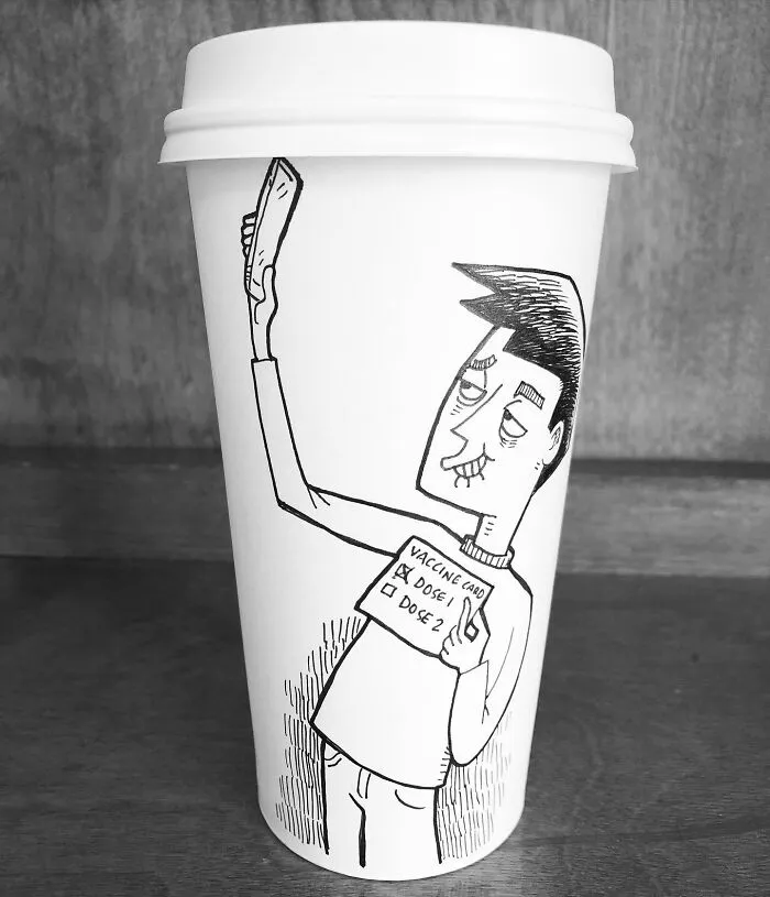 Coffee cup featuring a humorous cartoon of a person holding a vaccine card, illustrating relatable coffee cup art.