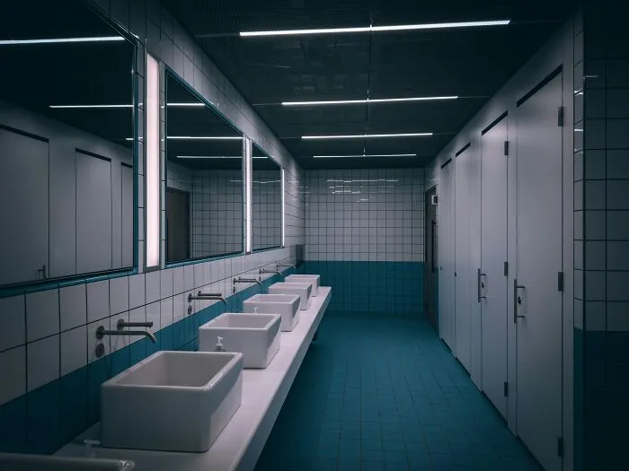 Modern public restroom with multiple sinks and stalls, highlighting surprising things travelers share about the U.S.