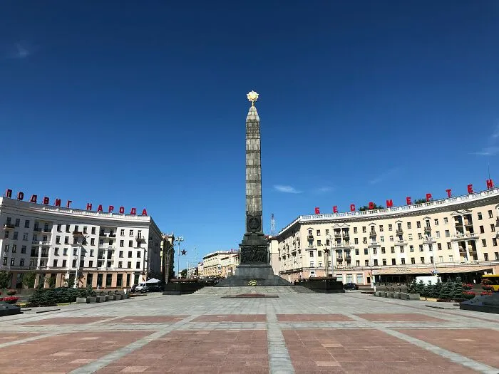 Monument in a city square under clear blue sky representing one of the smartest countries shaping the future of the world.