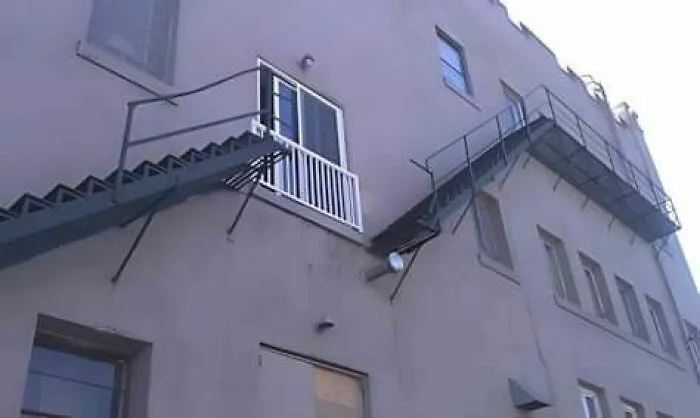 Building with an engineering design fail showing a door opening to an empty drop outside instead of a balcony.