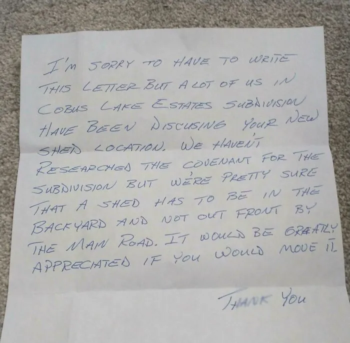 Handwritten neighbor's note about shed location rules, showcasing unhinged neighbors’ notes in shared living spaces.