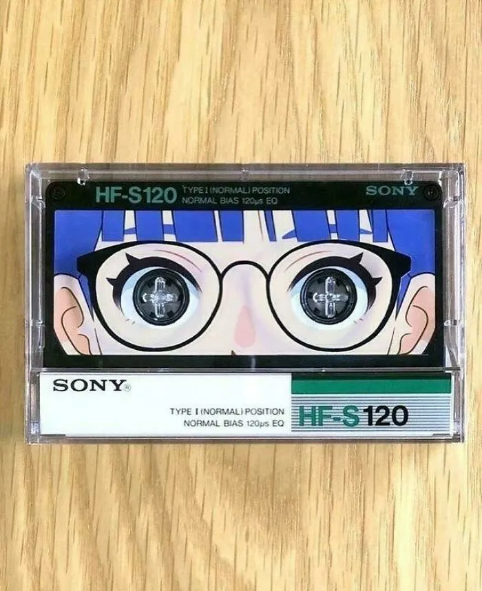 Cassette tape with creative design featuring a cartoon face with glasses and detailed eyes, showcasing smart and cool design.