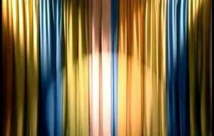 Curtains in blue and yellow colors with a spotlight, evoking nostalgic feelings and memories of old age.